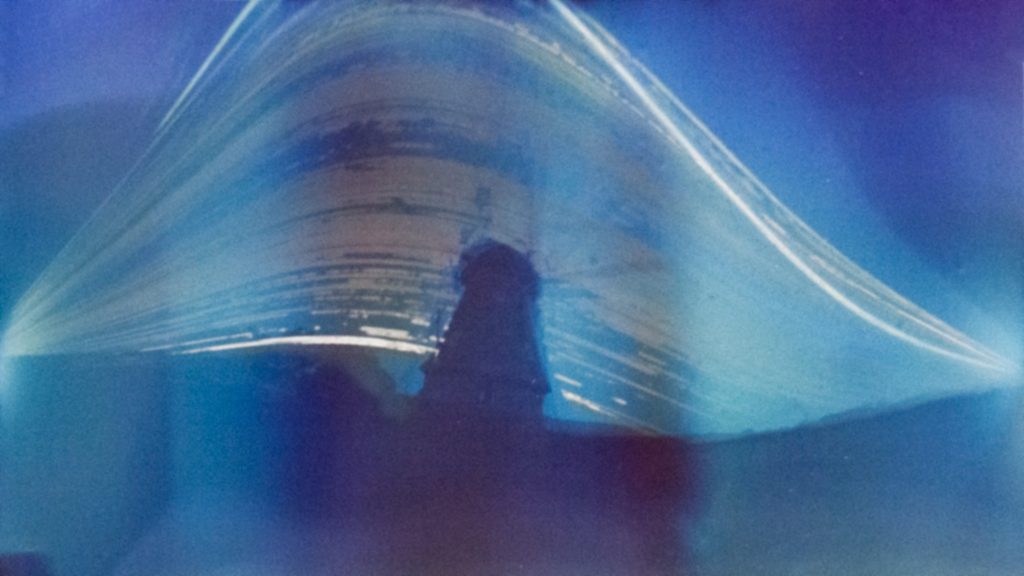 Solar trails behind a windmill